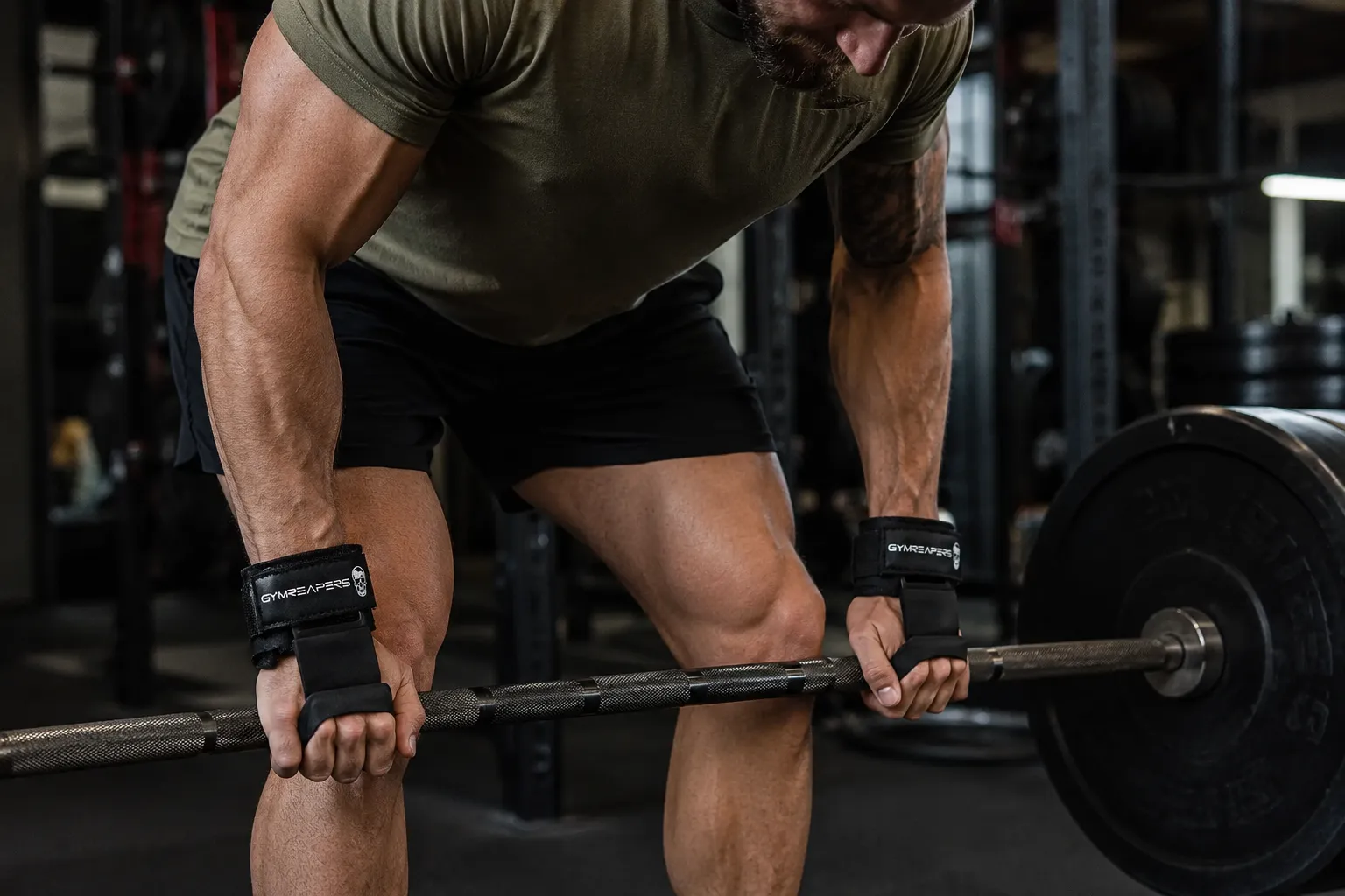 Gymreapers lifting hooks used on a barbell during a heavy pulling workout